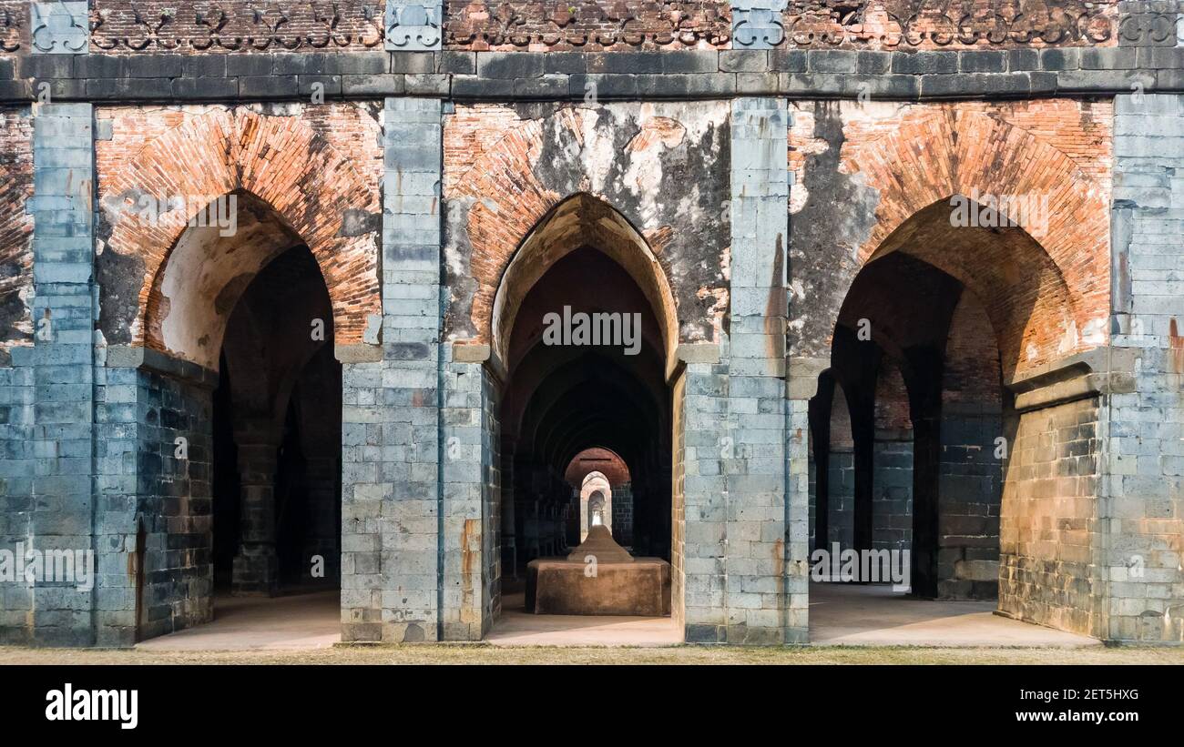 A stone tomb in an arcaded hall at the ruins of the ancient Adina Masjid mosque in the village of Pandua. Stock Photo