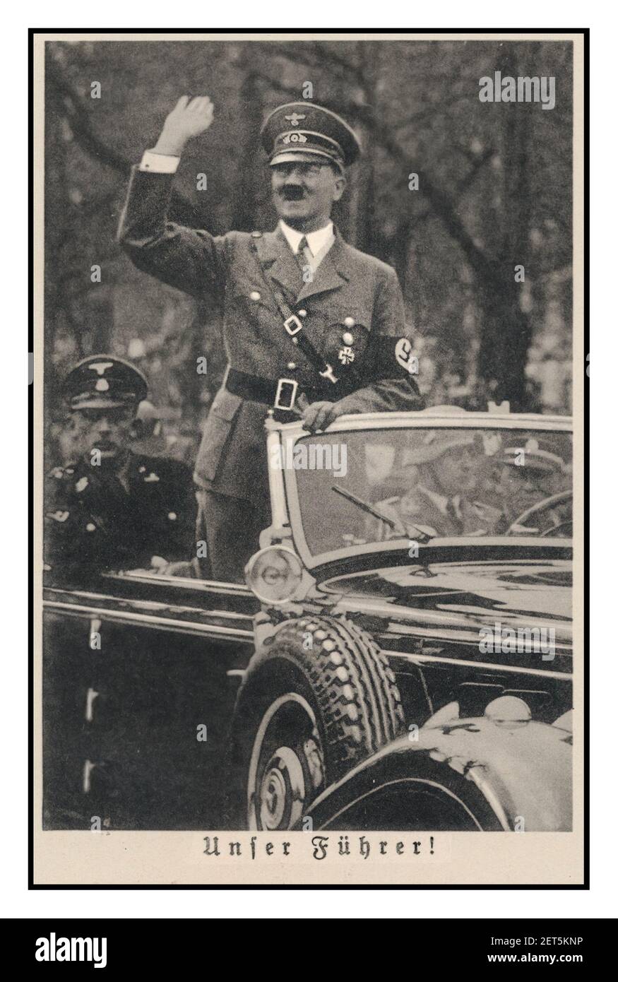 Vintage Nazi Propaganda image of 1940's Adolf Hitler in open top Mercedes saluting Heil Hitler to the crowds  'UNFER FÜHRER' OUR LEADER ! Stock Photo