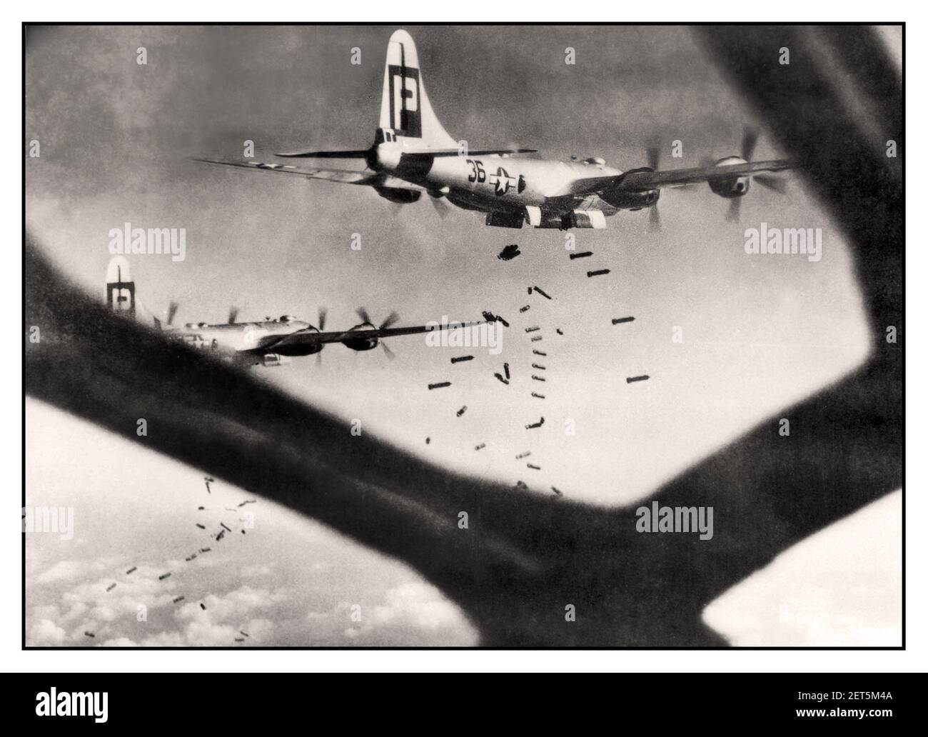 WW2 B-29 bombers on a bombing run over Hiratsuka Japan viewed through from bomb aiming nose cone window July 16, 1945 view of two 39th Bomb Group B-29s out of North Field (Andersen) on a mission over Japan. World War II Second World War Pacific War Stock Photo