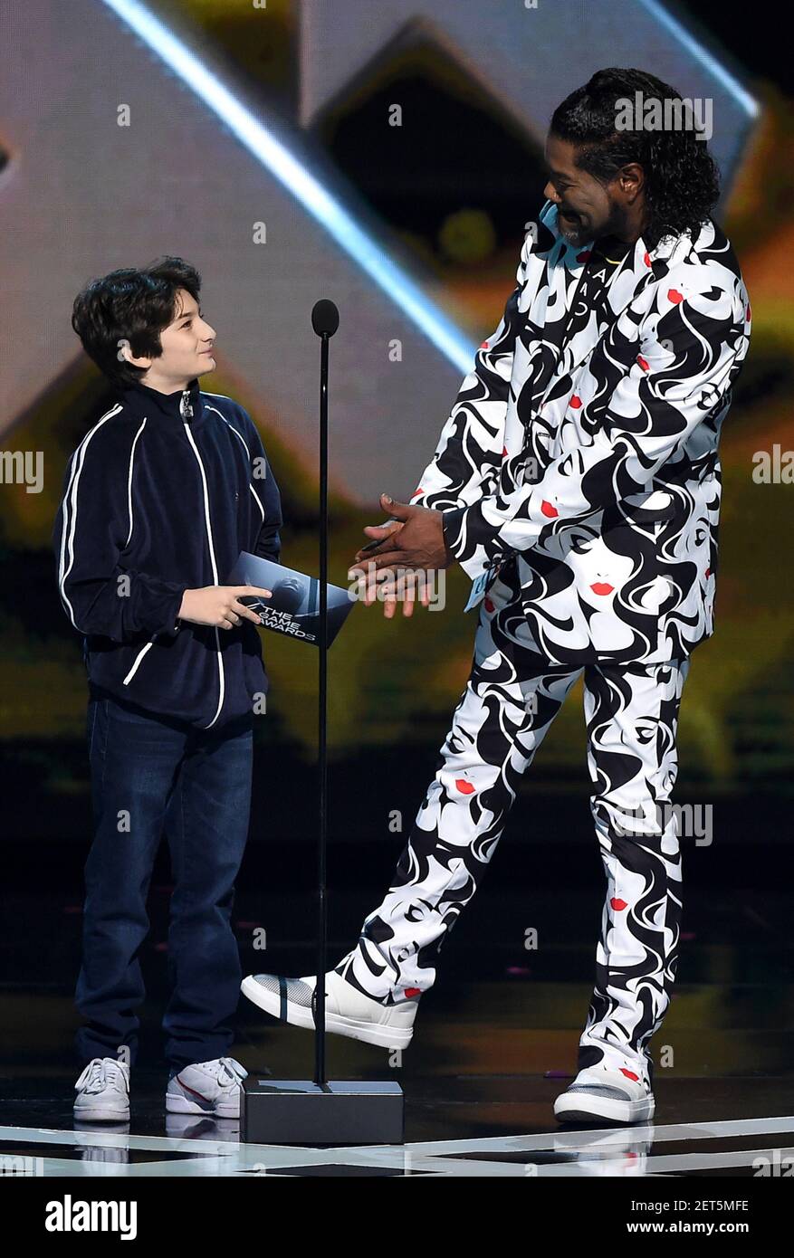 LOS ANGELES - DECEMBER 6: Presenters Sunny Sulijic and Christopher Judge  appear onstage at the 2018 Game Awards at the Microsoft Theater on December  6, 2018 in Los Angeles, California. (Photo by