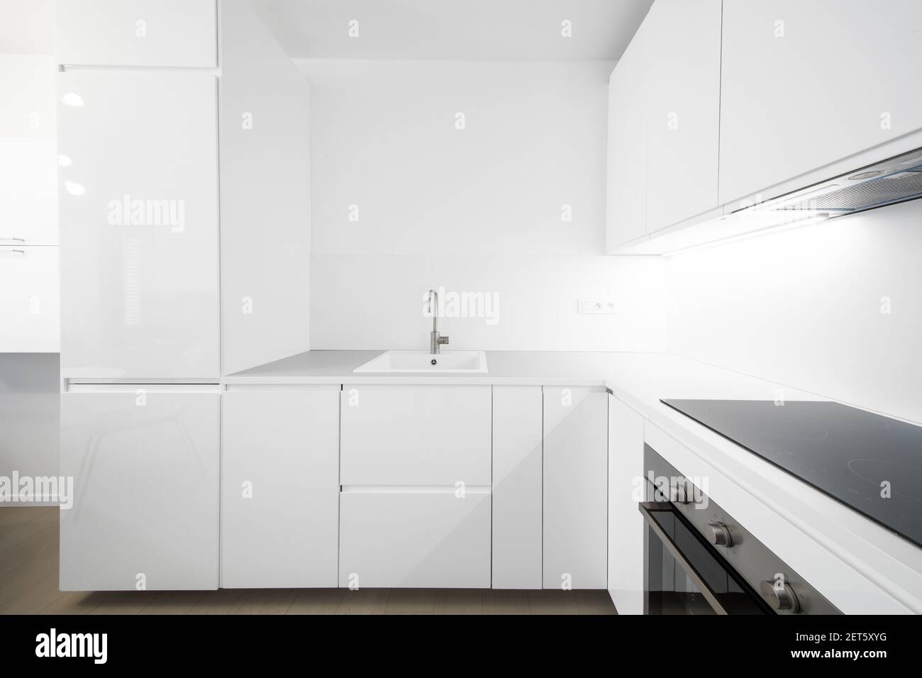 white kitchen in a modern apartment Stock Photo - Alamy