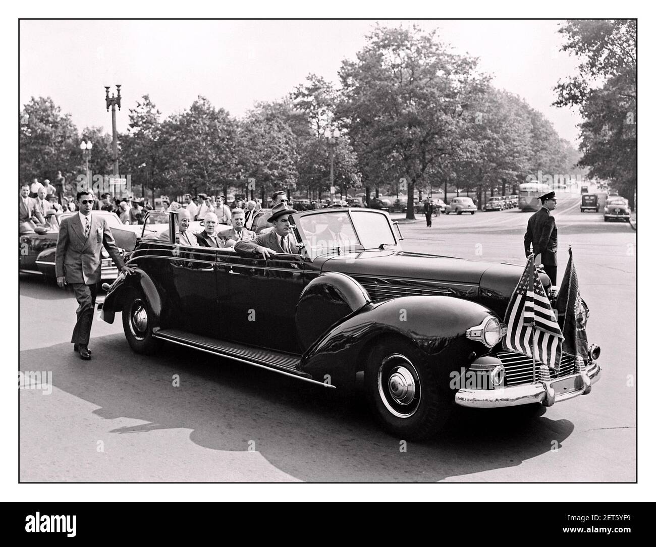 Vintage 1948 Harry Truman Lincoln Model K 'Sunshine Special' Presidential Convertible Limousine '1948 President Harry S. Truman with secret service security detail in and outside the presidential motorcar President Harry S. Truman and Vice President-elect Alben W. Barkley, riding in the back of an open car down a street in Washington, DC; President Truman smiles to the crowd. Truman and Barkley had just returned to Washington after winning the election of 1948. Stock Photo
