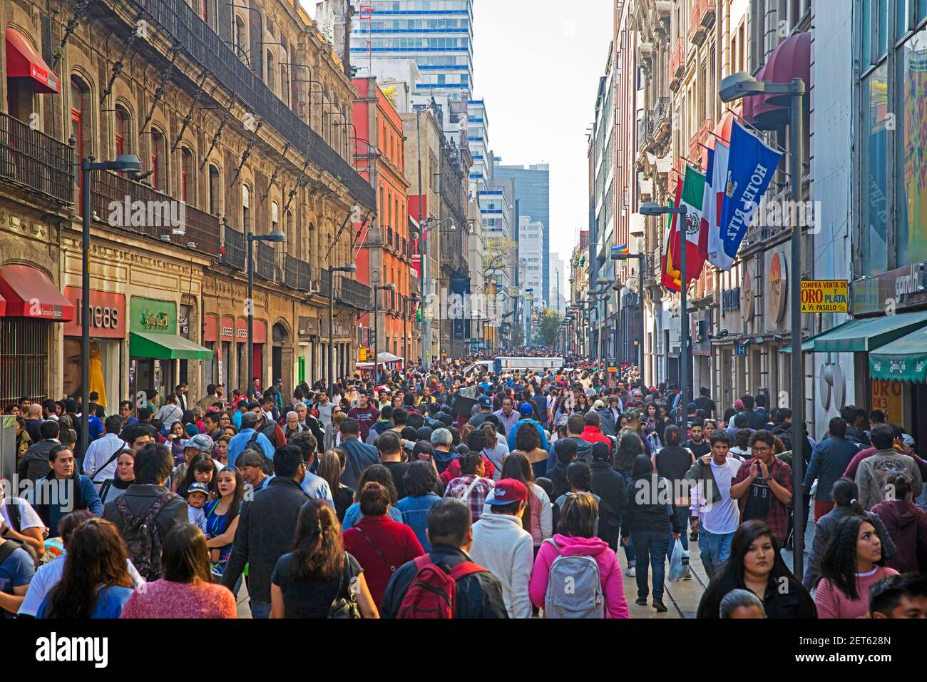 Pedestrians and shoppers walking in the Calle Madero / Francisco I. Madero Avenue / Madero Street in the historic city centre of Mexico City Stock Photo