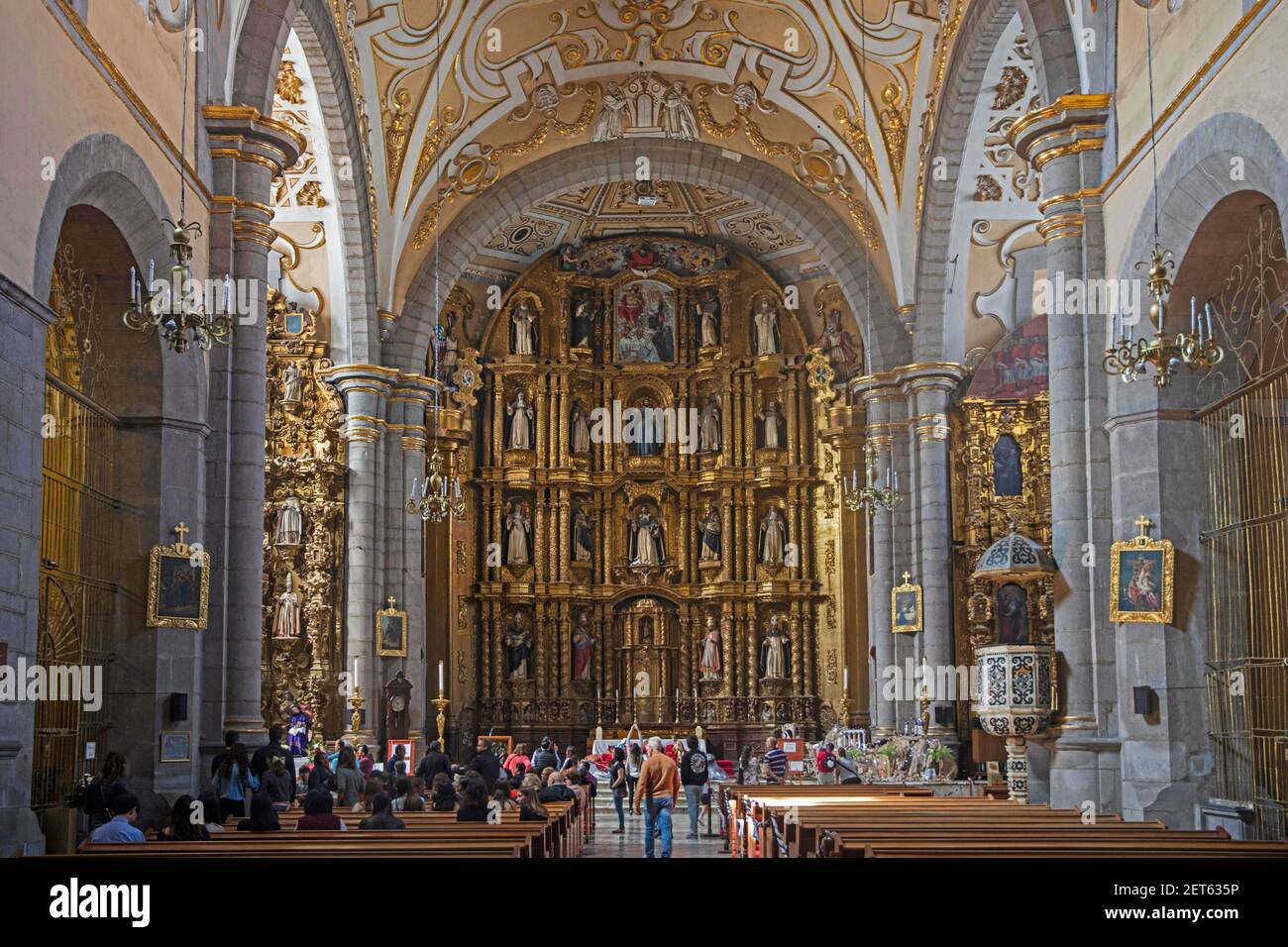 Interior of the 16th century Santa Domingo Church / Iglesia Santa Domingo showing impressive altarpiece in the city Puebla, Mexico Stock Photo