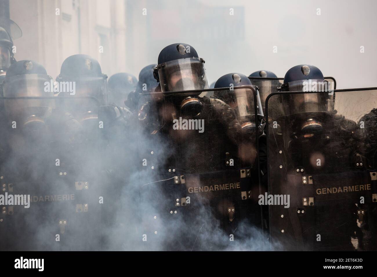 French riot-policemen with gas masks and shields stand guard, during the anti-government demonstrations in Paris, France, December 08, 2018. The withdrawal of French President Emmanuel Macron from implementing the Polluting Fuels tax, had very little to no effect on calming the tense situation in France as mass violent demonstrations continue to take place through several flashpoints across the country. In the French capital, members of the 'Yellow Jackets' movement along side high school students (protesting the education reform) and other citizens took to the streets. Stock Photo