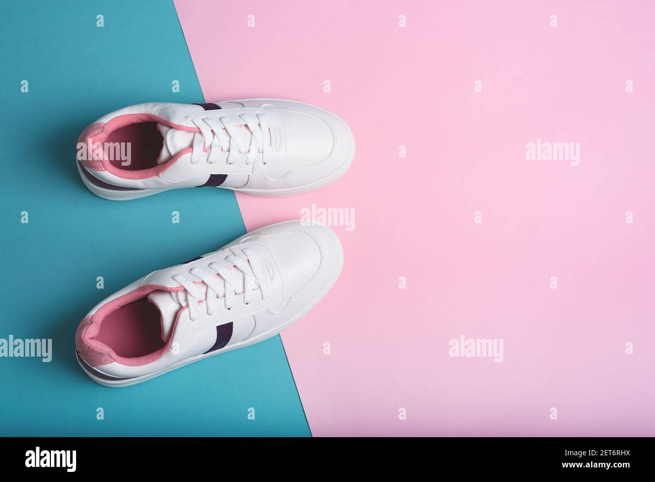 Flat lay of sport sneakers shoes on the blue and pink background ...