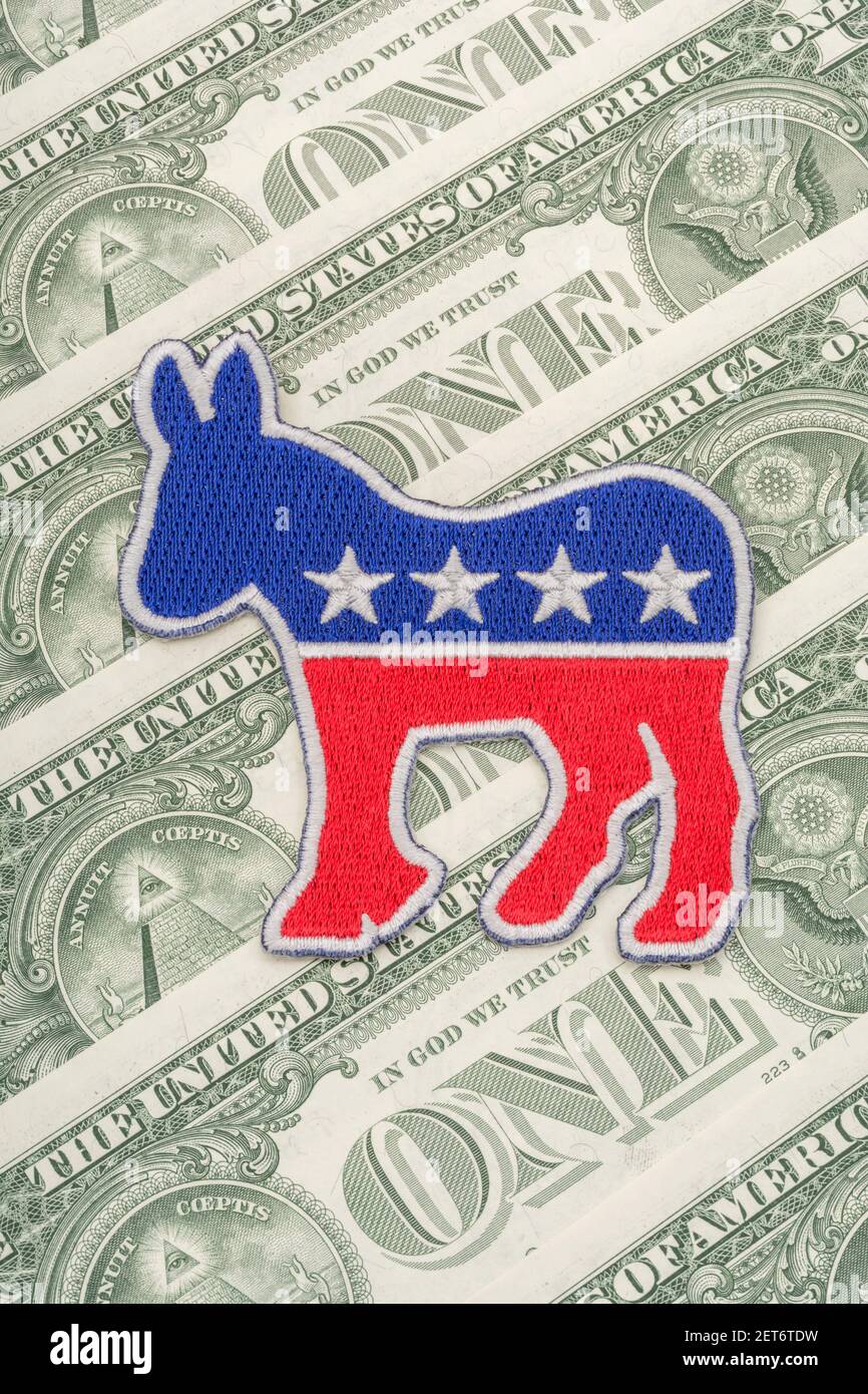 Democrat donkey logo patch badge & US $1 dollar banknotes. For US political fundraising & Democrat campaign funds, Biden debt pile, small $ donors Stock Photo