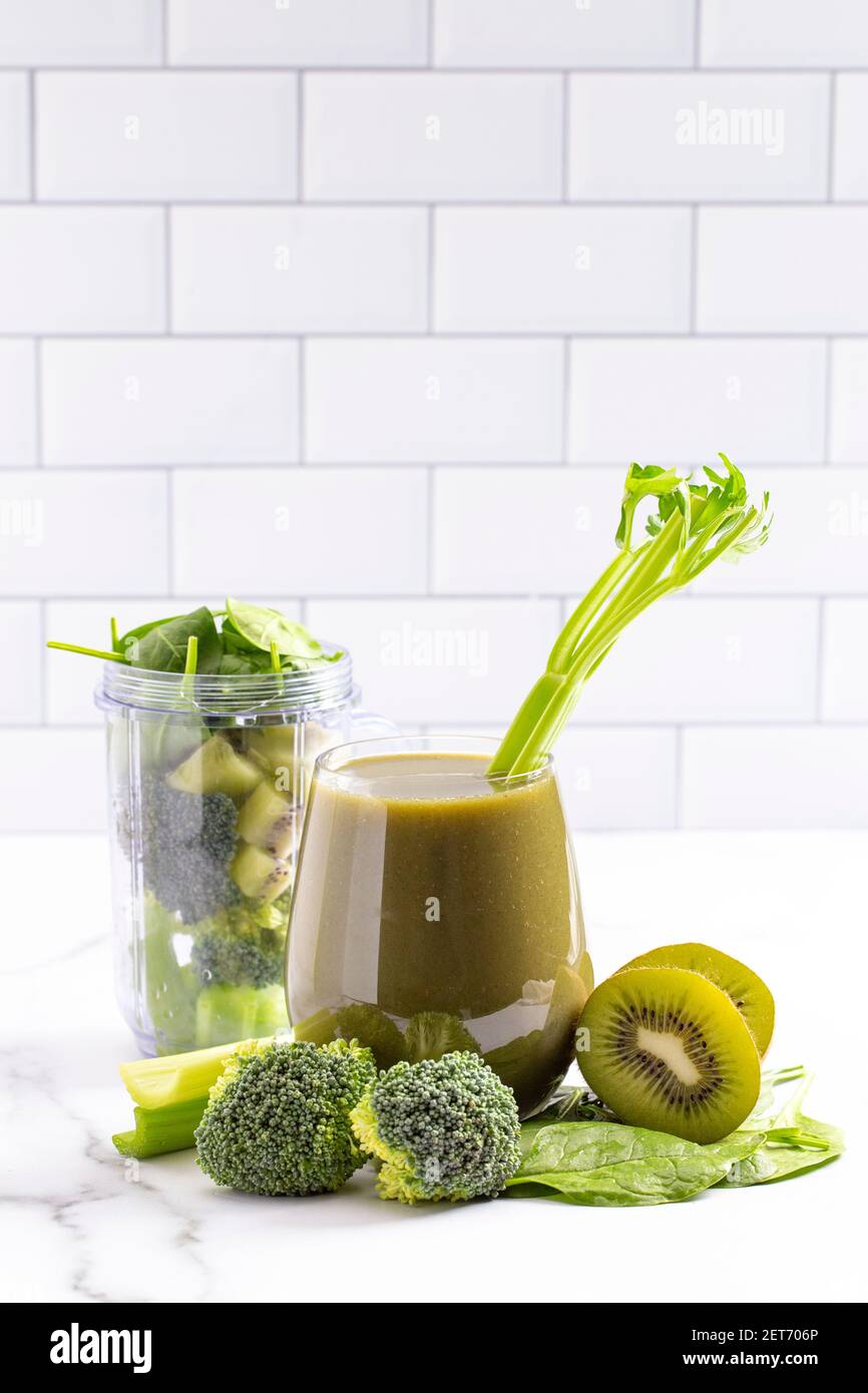 A Mix of Green Fruits and Vegetable Smoothie on a Bright White Kitchen