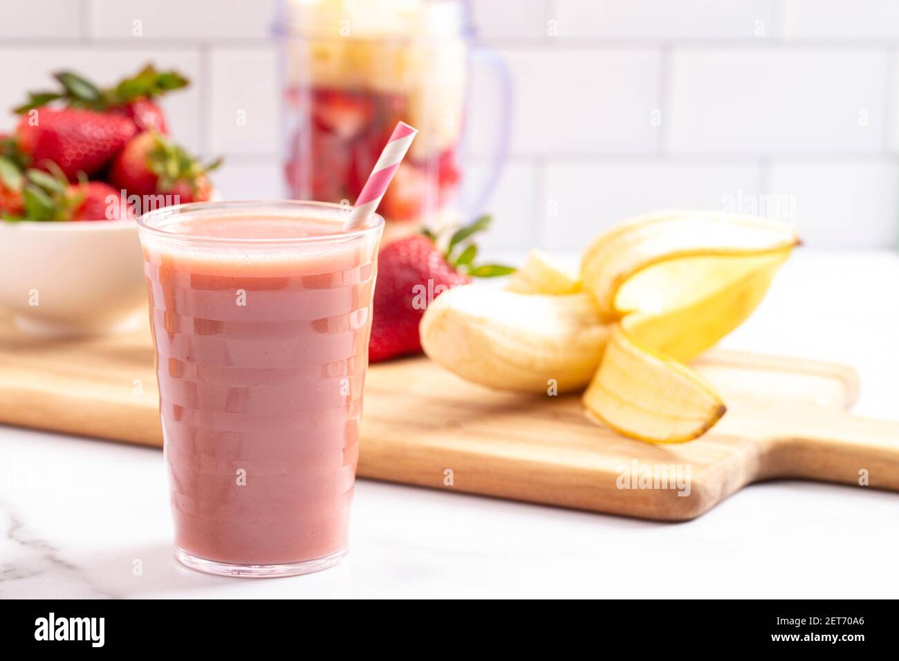 A Strawberry Banana Smoothie on a Bright White Kitchen Cabinet Stock ...