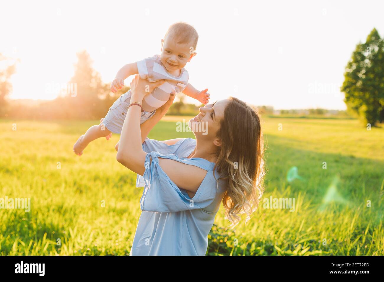 mom and son enjoying summer in the park relation concept caucasian Front or Back Yard play together sun light Stock Photo