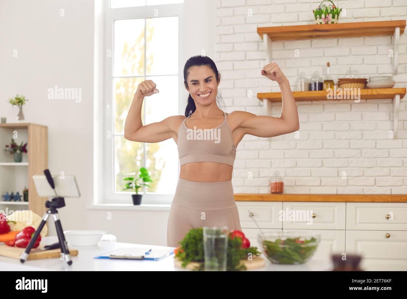 Fitness coach filming video where she is sharing dieting tips and setting healthy lifestyle example Stock Photo