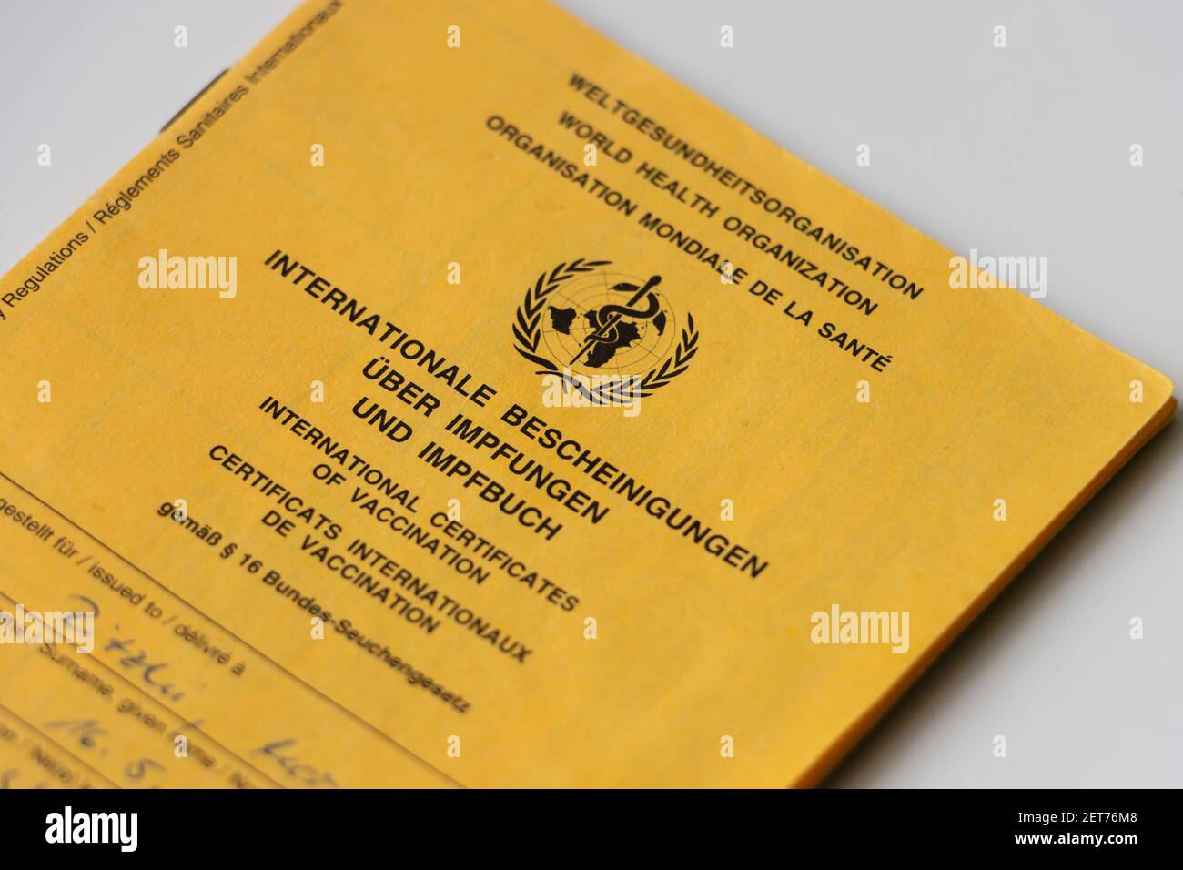 Front of the World Health Organization vaccination card. Yellow card with proof of necessary vaccinations. Internationally recognized ID. Health pass Stock Photo