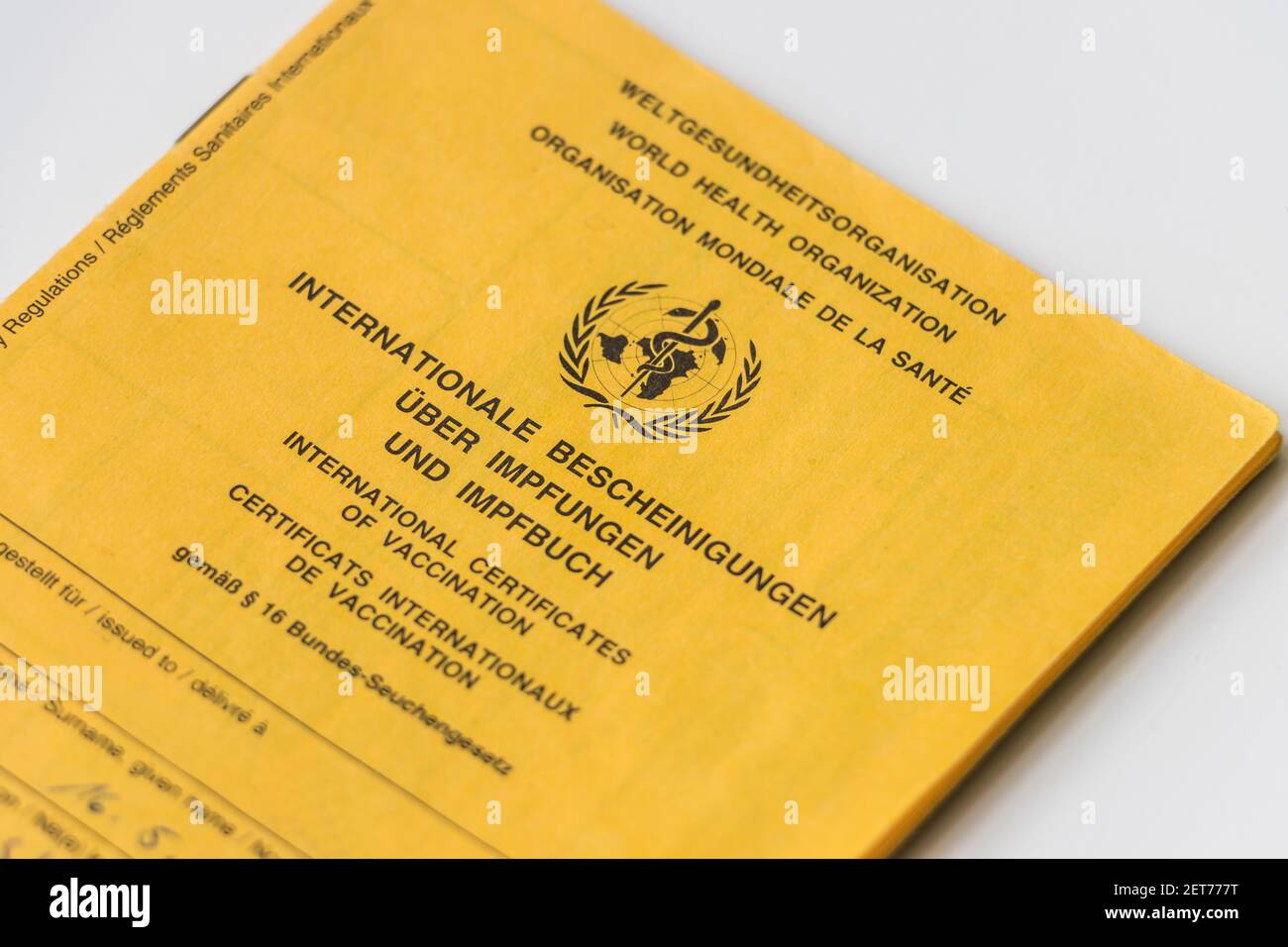Cover sheet from the World Health Organization vaccination card. Yellow card with proof of necessary vaccinations. Internationally recognized health Stock Photo