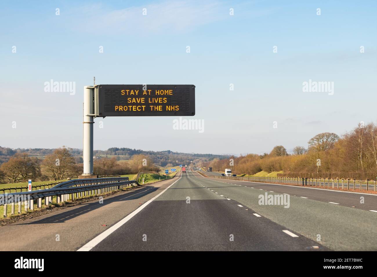 Stay at home Save Lives Protect the NHS sign on M74 Scotland, UK during coronavirus pandemic Stock Photo