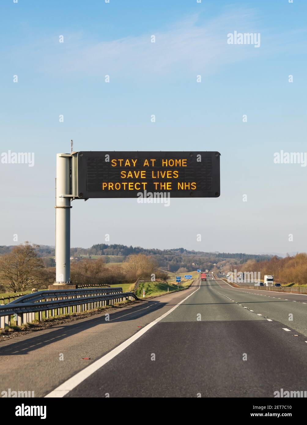 Stay at home Save Lives Protect the NHS sign on M74 Scotland, UK during coronavirus pandemic Stock Photo
