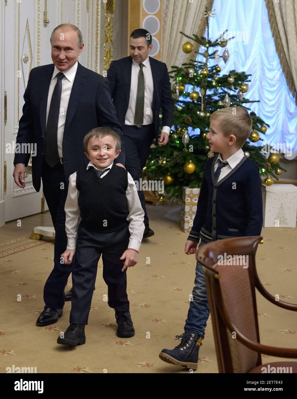 Working visit of Russian President Vladimir Putin to St. Petersburg. Russian President Vladimir Putin and Artem Palyanov (second left), a boy, whose dream Vladimir Putin promised to fulfill at the International Volunteer Forum on December 5, during a meeting in the Konstantinovsky Palace. 14-year-old 'crystal boy' Artem Palyanov from the village of Taitsy asked for a helicopter tour over St. Petersburg. December 15, 2018. Russia, St. Petersburg. Photo credit: Dmitry Azarov/Kommersant/Sipa USA  Stock Photo