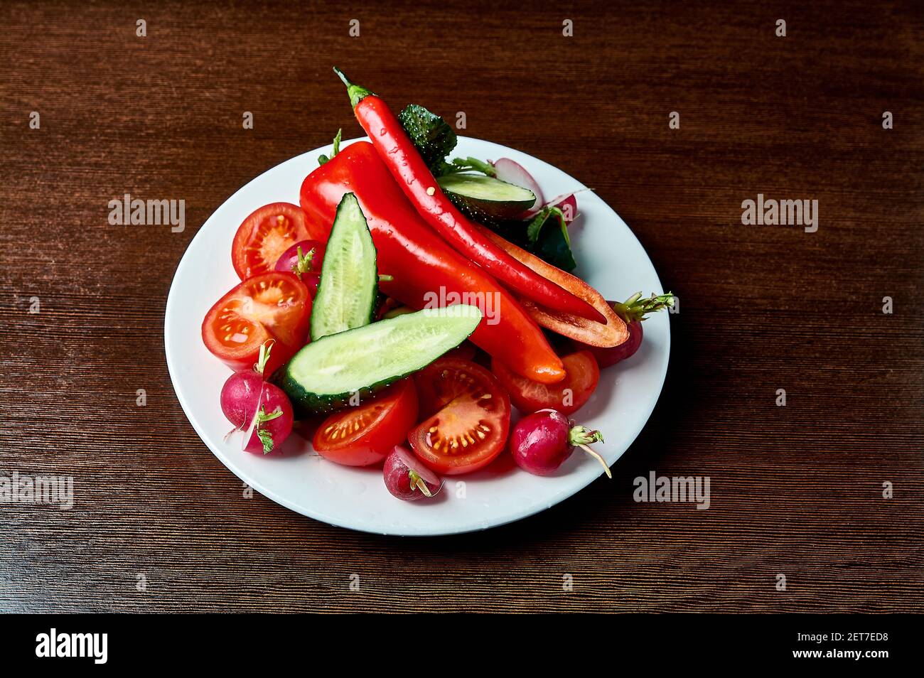 slicing fresh vegetables on a plate Stock Photo