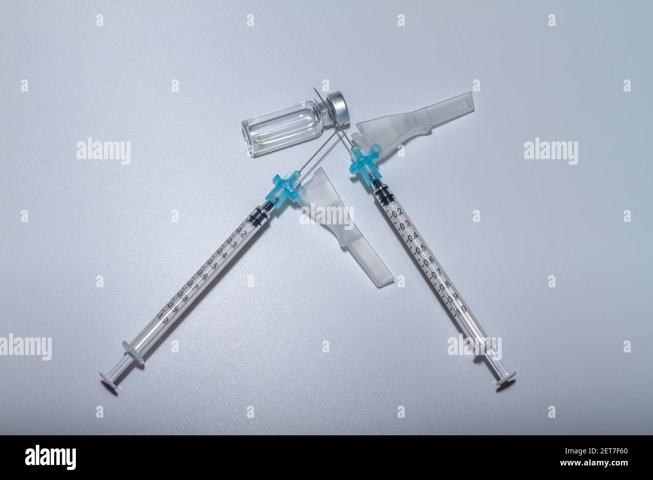 Two dose vaccination concept. Two syringes on a vial of vaccine against ...