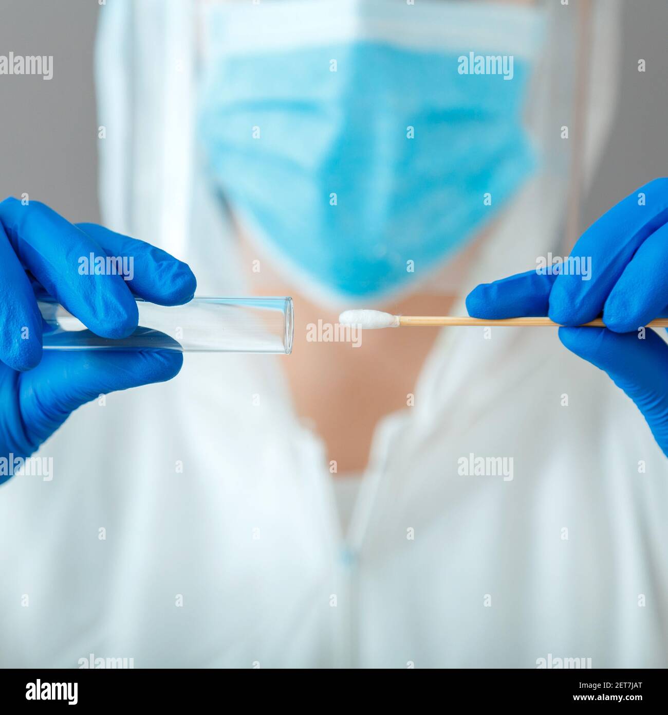 Covid 19 pcr test in nurse hands. Doctor in protective suit medical mask gloves holding Swab saliva sample for diagnostic covid19 coronavirus virus in Stock Photo