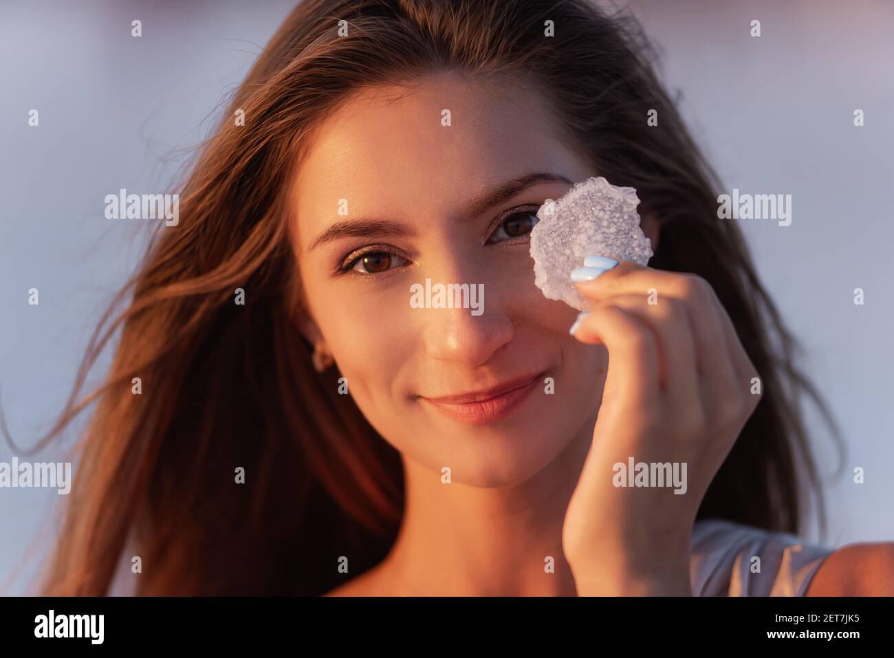 Close-up portrait of a young blonde woman holding a piece of crystallized white  salt in her hands. Girl with natural make-up, hair is developing. Salt  Stock Photo - Alamy