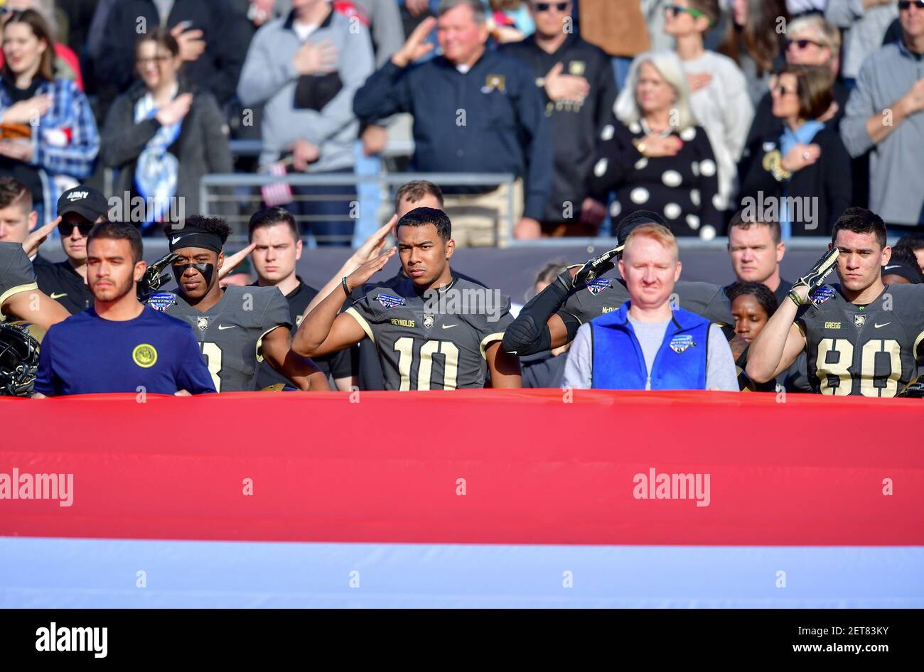 Army team members salute during opening ceremonies at the Lockheed ...