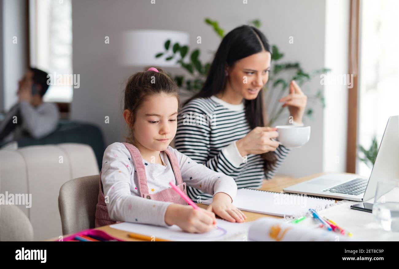 Mother with school girl indoors at home, distance learning and home ...