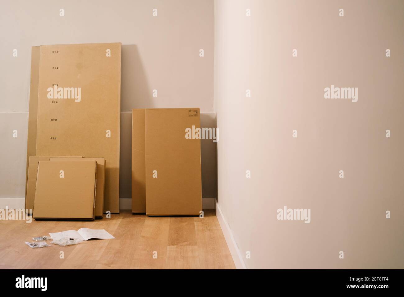 Furniture box in an empty room to assemble yourself Stock Photo Alamy