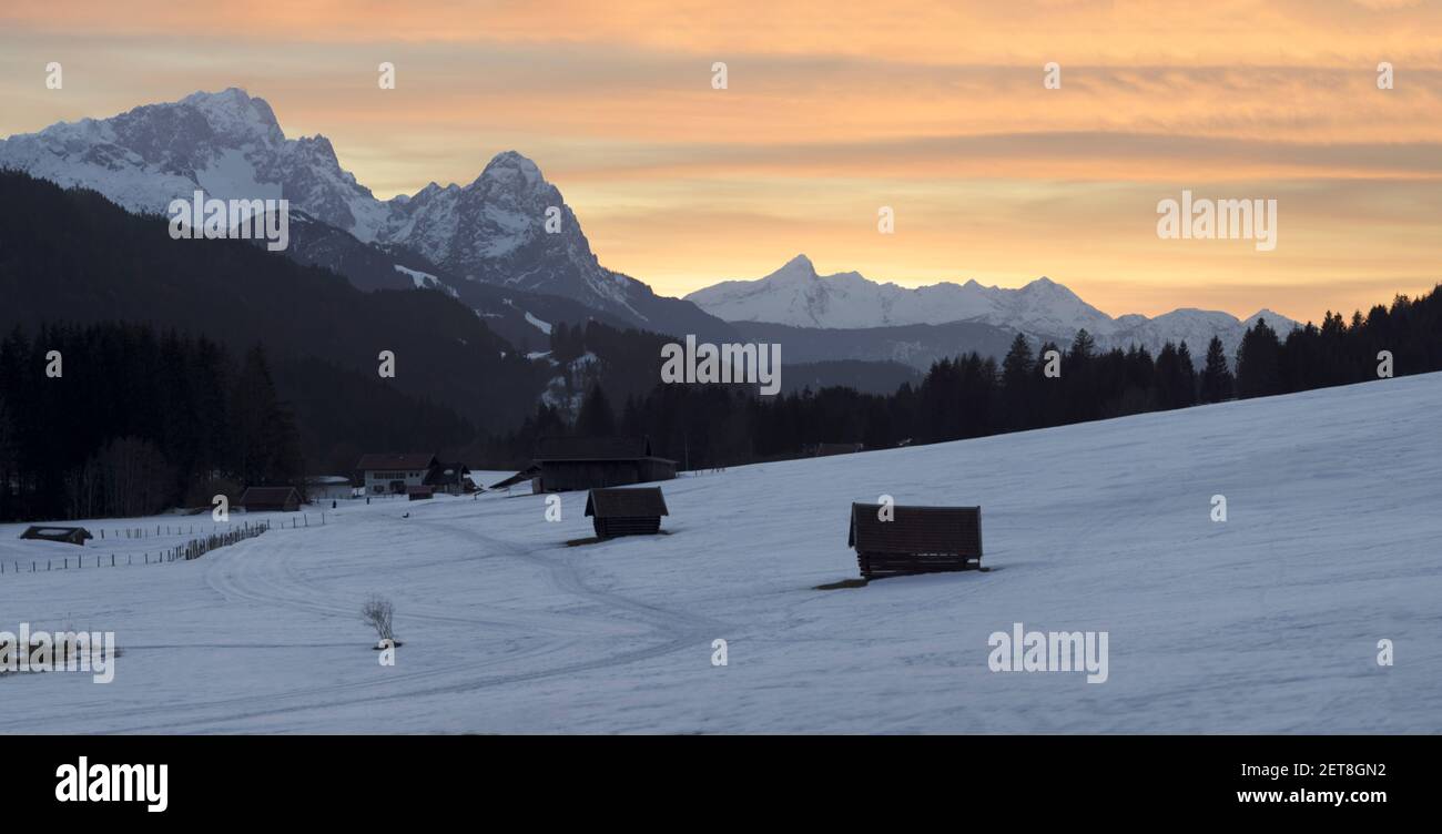 sunset in the mountains - wooden huts and sahara sand creating epic atmosphere Stock Photo