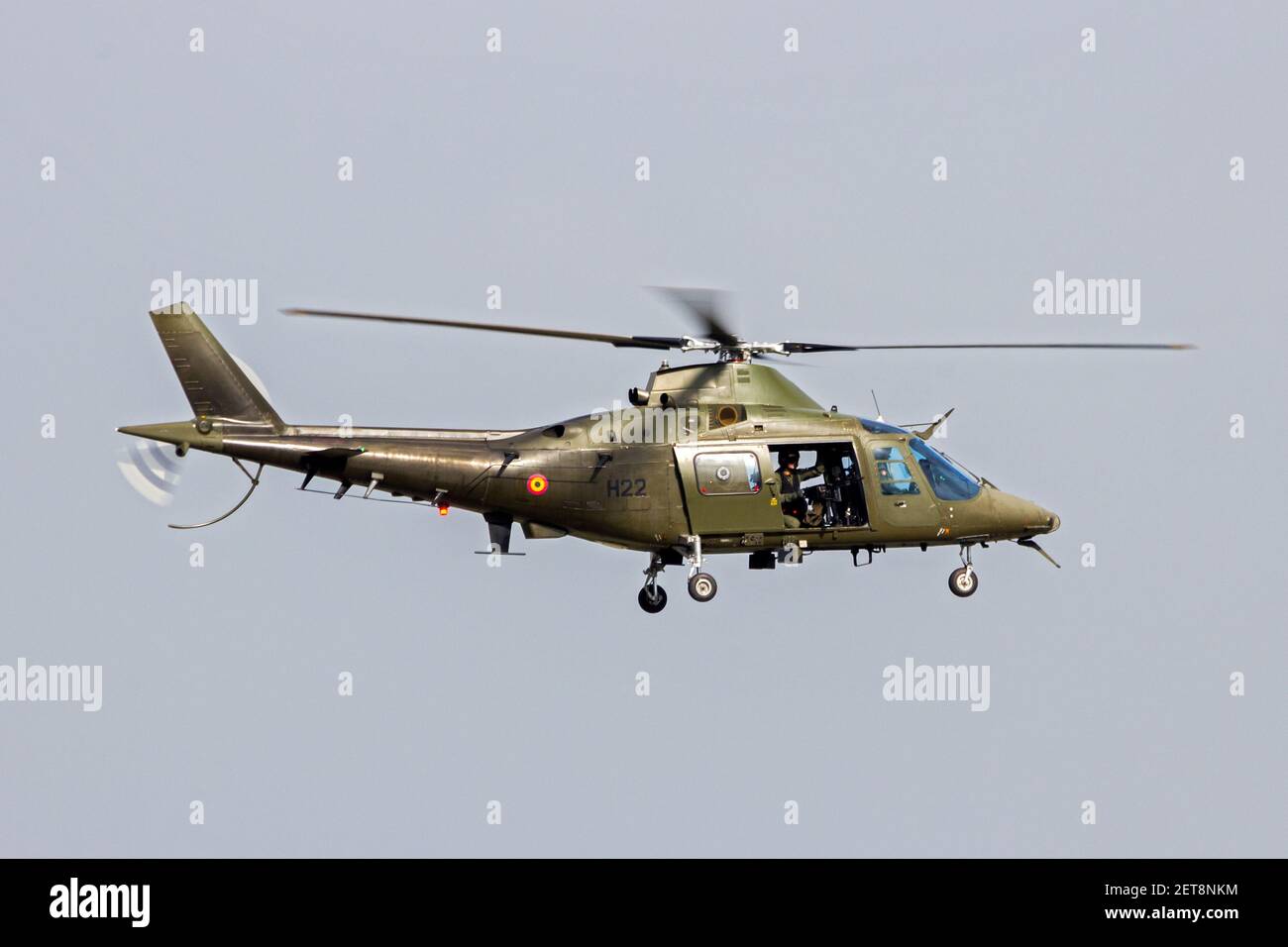 Belgian Air Force Agusta A109 helicopter with door gunner in flight over Kleine Brogel Air Base. Belgium - September 13, 2014 Stock Photo