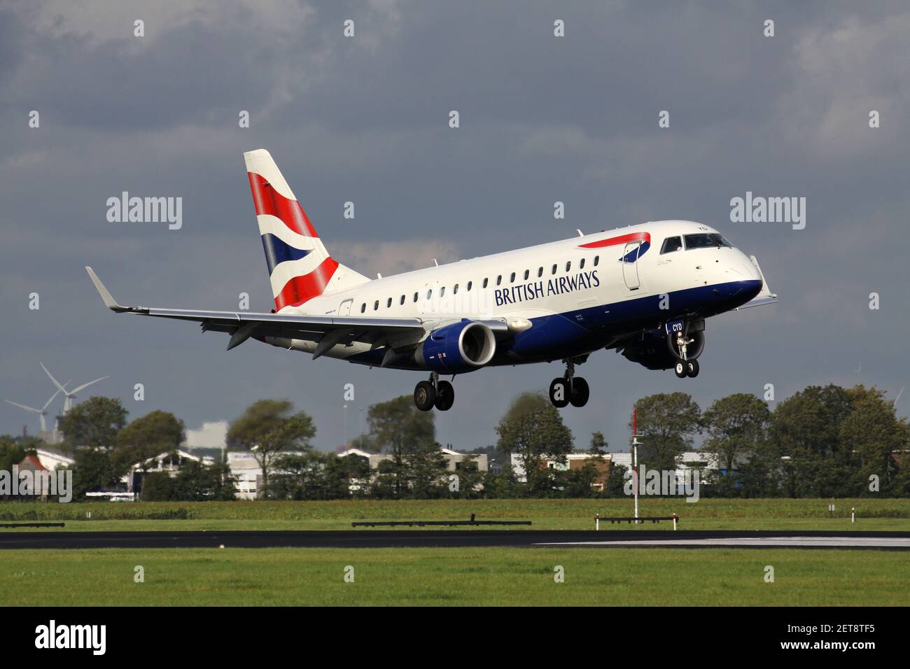 BA CityFlyer Embraer ERJ-175 with registration G-LCYD short final for runway 18R (Polderbaan) of Amsterdam Airport Schiphol. Stock Photo