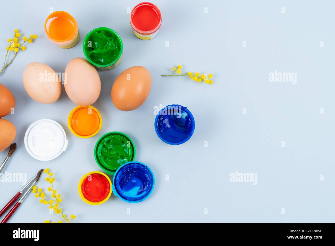 Eggs and paints. Easter eggs decoration process. Copy space. Top view. Stock Photo