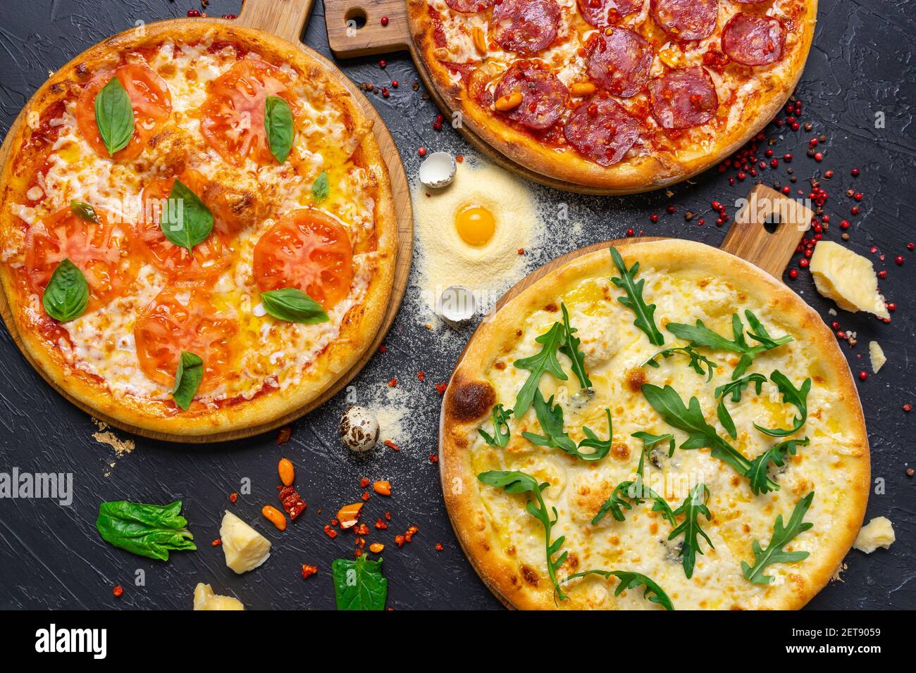 three delicious pizza on concrete, top view Stock Photo