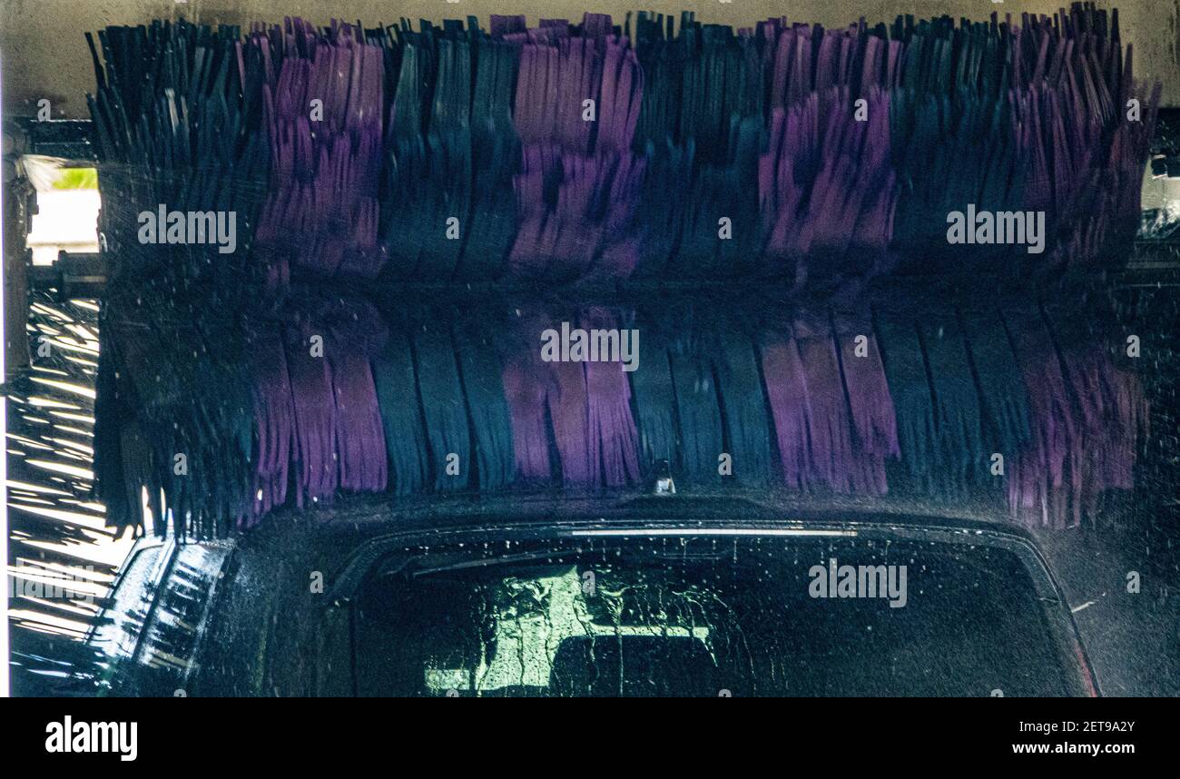 A car being washed in an automated machine jet car wash Stock Photo - Alamy
