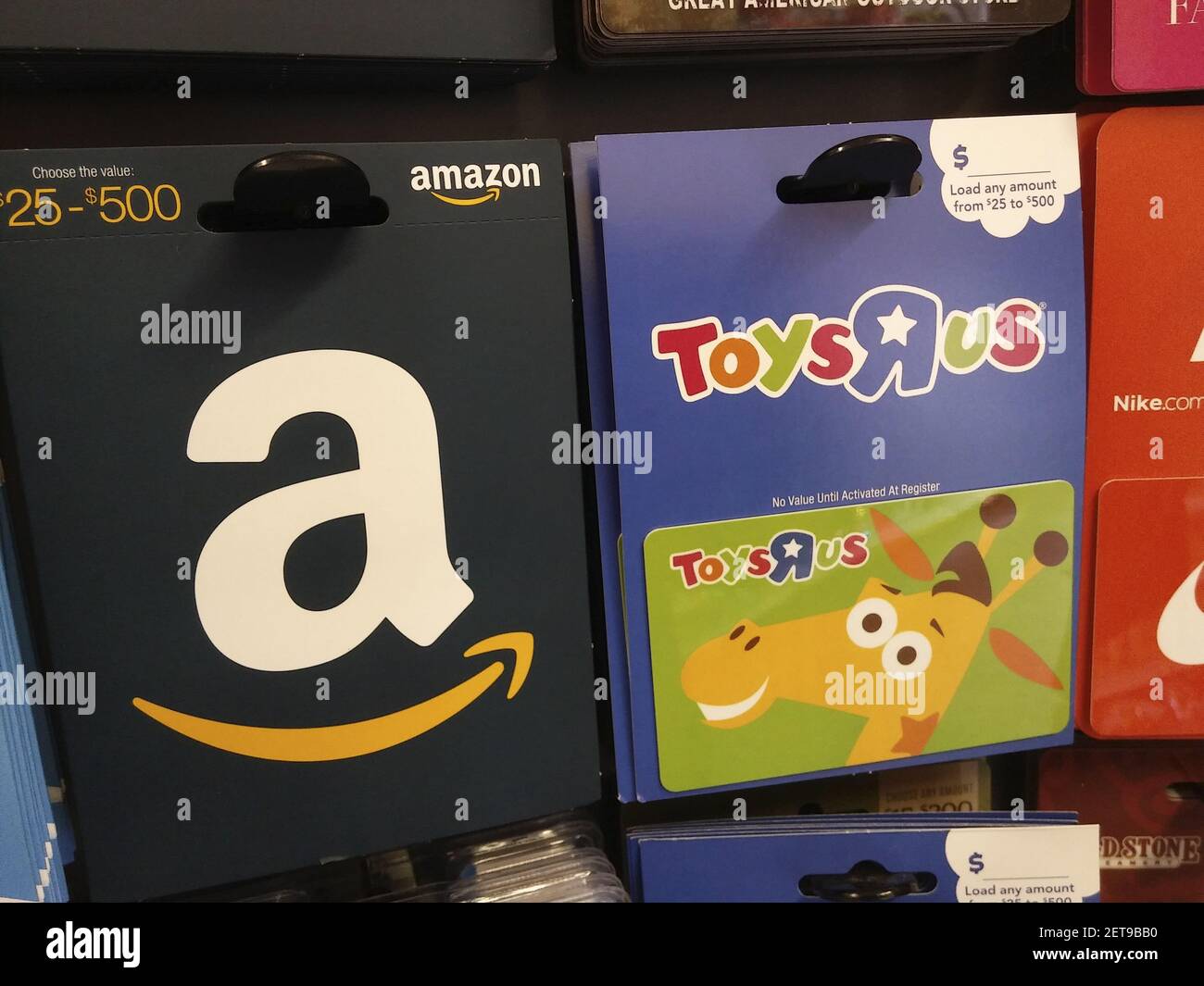 Toys R Us and amazon branded gift cards in a rack in a drugstore in New  York on Saturday, March 10, 2018. Tru Kids Brands, the owner of the Toys R  Us