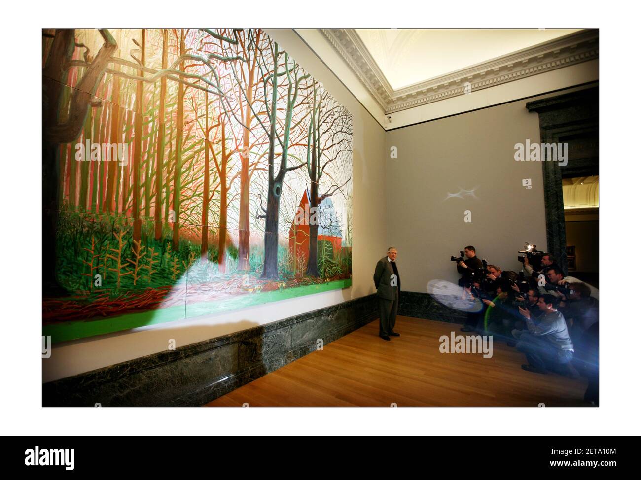 British artist David Hockney (L) poses for photographs next to a segment of his painting 'Bigger Tree's near Warter', at the Tate Britain in London. David Hockney has donated the artwork to the Tate Britainphotograph by David Sandison The Independent 7/4/2008 Stock Photo