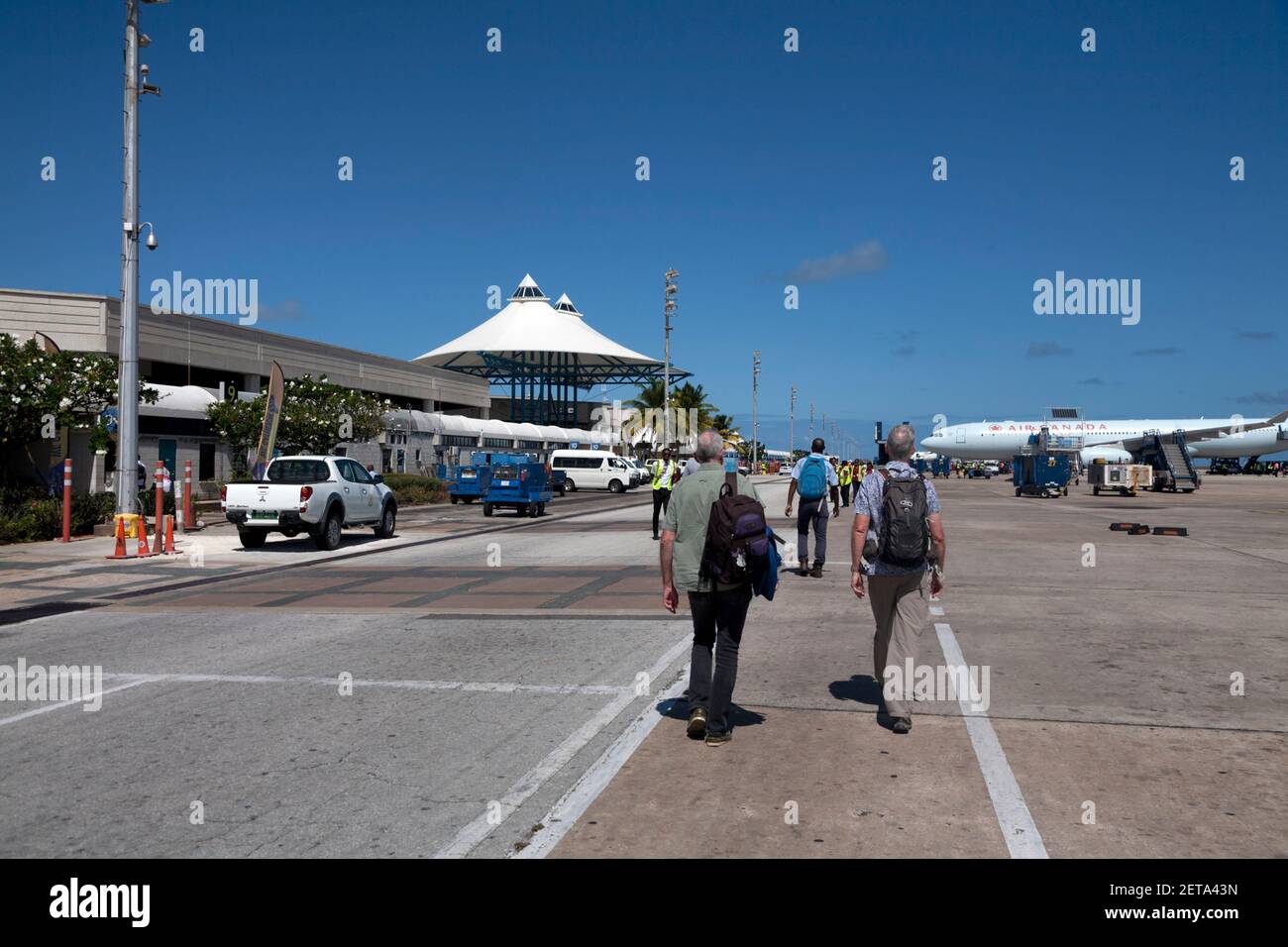 passengers walking from aircraft to terminal building at grantley adams  international airport seawell christ church barbados windward islands west in Stock Photo