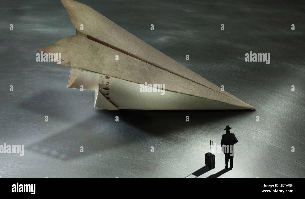 a man dressed in a trench coat and a wide-brimmed hat, with his luggage, is waiting to board a huge paper plane, Nighttime atmosphere like a dream.. Stock Photo
