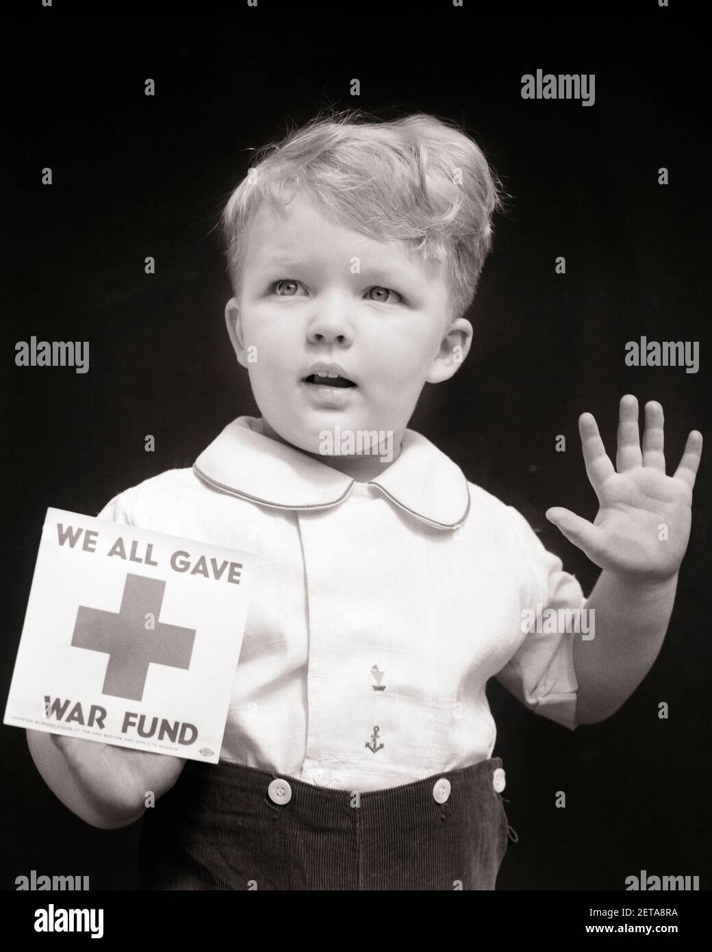 1940s TODDLER BOY IN WINDOW WITH WE ALL GAVE WORLD WAR 2 FUND RED CROSS DECAL  - d1641 HAR001 HARS STUDIO SHOT HOME LIFE COPY SPACE HALF-LENGTH INSPIRATION CARING MALES B&W BOND FREEDOM EFFORT WORLD WARS WORLD WAR WORLD WAR TWO WORLD WAR II APPEAL FUND RED CROSS WORLD WAR 2 BABY BOY DONATIONS COOPERATION FUND RAISING GROWTH JUVENILES BLACK AND WHITE CAUCASIAN ETHNICITY FIRST AID HAR001 OLD FASHIONED Stock Photo