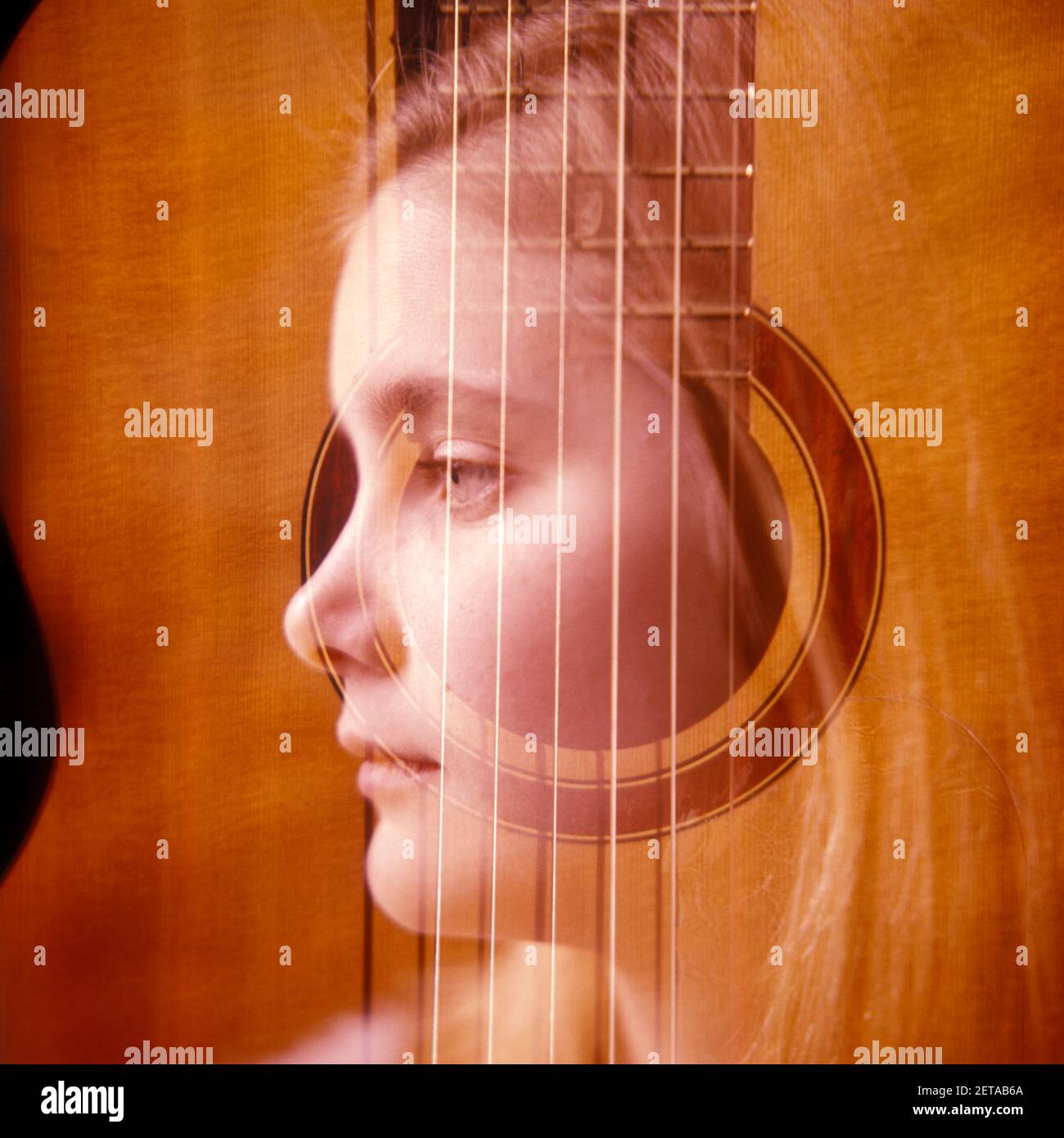 1970s 1980s HEAD PROFILE BLONDE GIRL MOODY WITH CENTER & STRINGS OF ACOUSTIC GUITAR SUPERIMPOSED MUSIC  - kj8886 AMF001 HARS PENSIVE PERSONS THOUGHTFUL INSPIRATION TEENAGE GIRL STRINGS SADNESS DREAMS HEAD AND SHOULDERS DISCOVERY ACOUSTIC COMPOSITE SONG REFLECTIVE THINK OPPORTUNITY REFLECTING MUSICAL INSTRUMENT PONDER PONDERING CONSIDER LOST IN THOUGHT FOLK IMAGINATION TEENAGED CONTEMPLATIVE MEDITATE CREATIVITY JUVENILES MEDITATIVE PRE-TEEN PRE-TEEN GIRL CAUCASIAN ETHNICITY CONSIDERING OLD FASHIONED SUPERIMPOSED Stock Photo