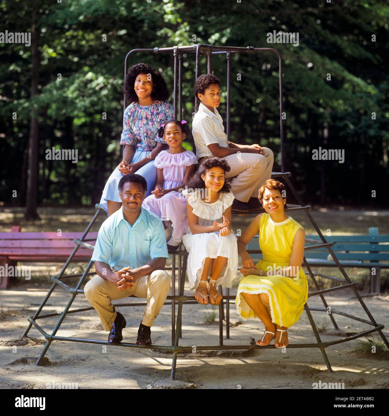 1980s FAMILY PORTRAIT AFRICAN-AMERICAN MOTHER FATHER AND 4 CHILDREN A BOY AND THREE GIRLS SITTING ON PLAYGROUND MONKEY BARS - kj9411 TEU001 HARS PLAYGROUND MOM NOSTALGIC PAIR 4 COMMUNITY COLOR MOTHERS OLD TIME NOSTALGIA OLD FASHION 1 JUVENILE SONS PLEASED FAMILIES JOY LIFESTYLE FEMALES MARRIED SPOUSE HUSBANDS HEALTHINESS 6 FRIENDSHIP LADIES DAUGHTERS PERSONS MALES TEENAGE GIRL SIX FATHERS PARTNER HAPPINESS WELLNESS CHEERFUL AFRICAN-AMERICANS AFRICAN-AMERICAN AND DADS BLACK ETHNICITY PRIDE SMILES CONNECTION JOYFUL JUVENILES MOMS PRE-TEEN PRE-TEEN BOY PRE-TEEN GIRL TOGETHERNESS WIVES MONKEY BARS Stock Photo