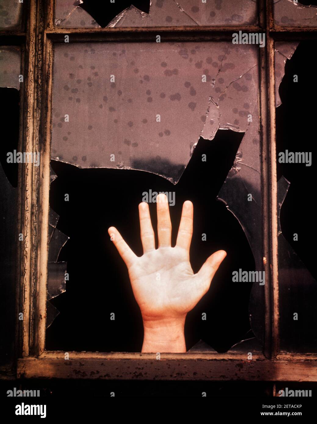 1970s BROKEN GLASS WINDOW ABANDONED BUILDING HAND WAVING SIGNALING HELP PROBLEM EERIE IN TROUBLE SYMBOLIC POVERTY MYSTERY  - ks6480 DAS001 HARS BIZARRE DISASTER STRUCTURE ARCHITECTURAL WEIRD DANGEROUS MANUAL GROTESQUE EERIE EXCITEMENT ZANY UNCONVENTIONAL ABANDONED SIGNALING CONCEPT CONCEPTUAL ESCAPE WACKY WRECK ARCHITECTURE DETAIL IDIOSYNCRATIC SYMBOLIC AMUSING ARCHITECTURAL DETAIL COMMUNICATE CONCEPTS DESPERATION DIRE ECCENTRIC SITUATION SLUM CAUCASIAN ETHNICITY DESPERATE ERRATIC HANDS ONLY OLD FASHIONED OUTRAGEOUS REPRESENTATION Stock Photo