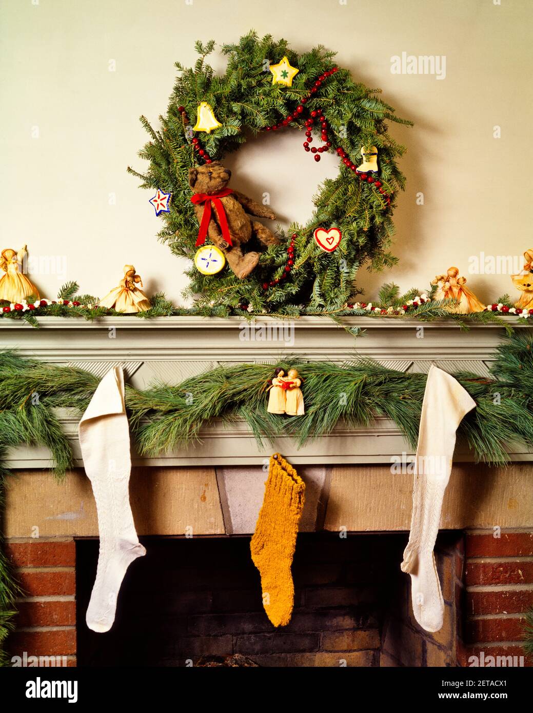 1980s Christmas Fireplace Mantle Decorated With Homespun Hand Crafted Items Wreath Garland Stockings Ornaments Kx10205 Teu001 Hars Chimney Old Fashioned Stock Photo Alamy