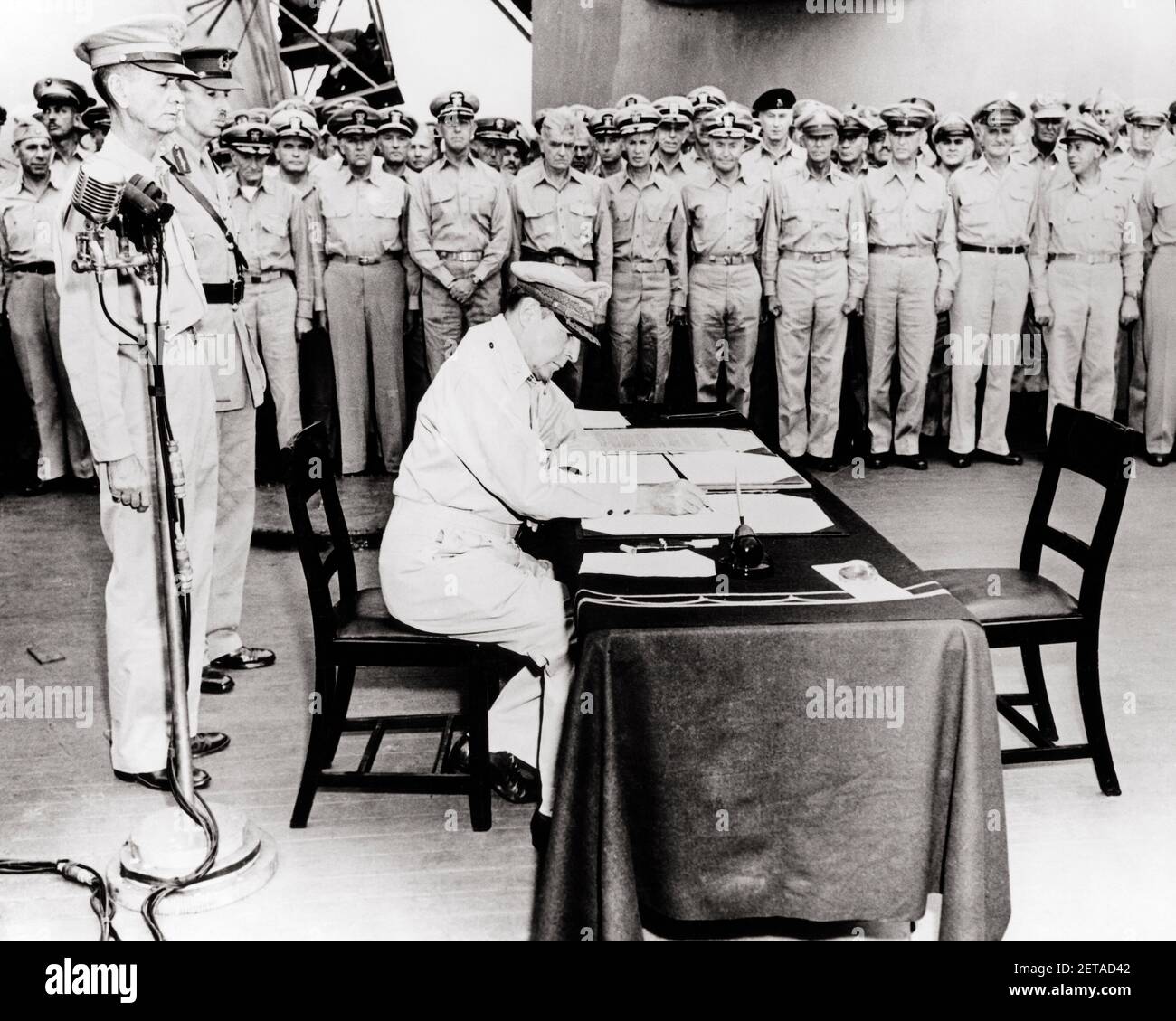 1940s SEPTEMBER 2 1945 GENERAL MACARTHUR SIGNS JAPANESE SURRENDER DOCUMENT ABOARD THE USS MISSOURI IN TOKYO BAY JAPAN - m3368 HAR001 HARS WORLD WAR II AUTHORITY MARINES OCCUPATIONS POLITICS UNIFORMS BATTLESHIP CONCEPTUAL STYLISH WORLD WAR 2 OFFICERS 1945 ADMIRALS SURRENDER USS ABOARD AUGUST BLACK AND WHITE CAUCASIAN ETHNICITY GENERALS HAR001 OLD FASHIONED Stock Photo