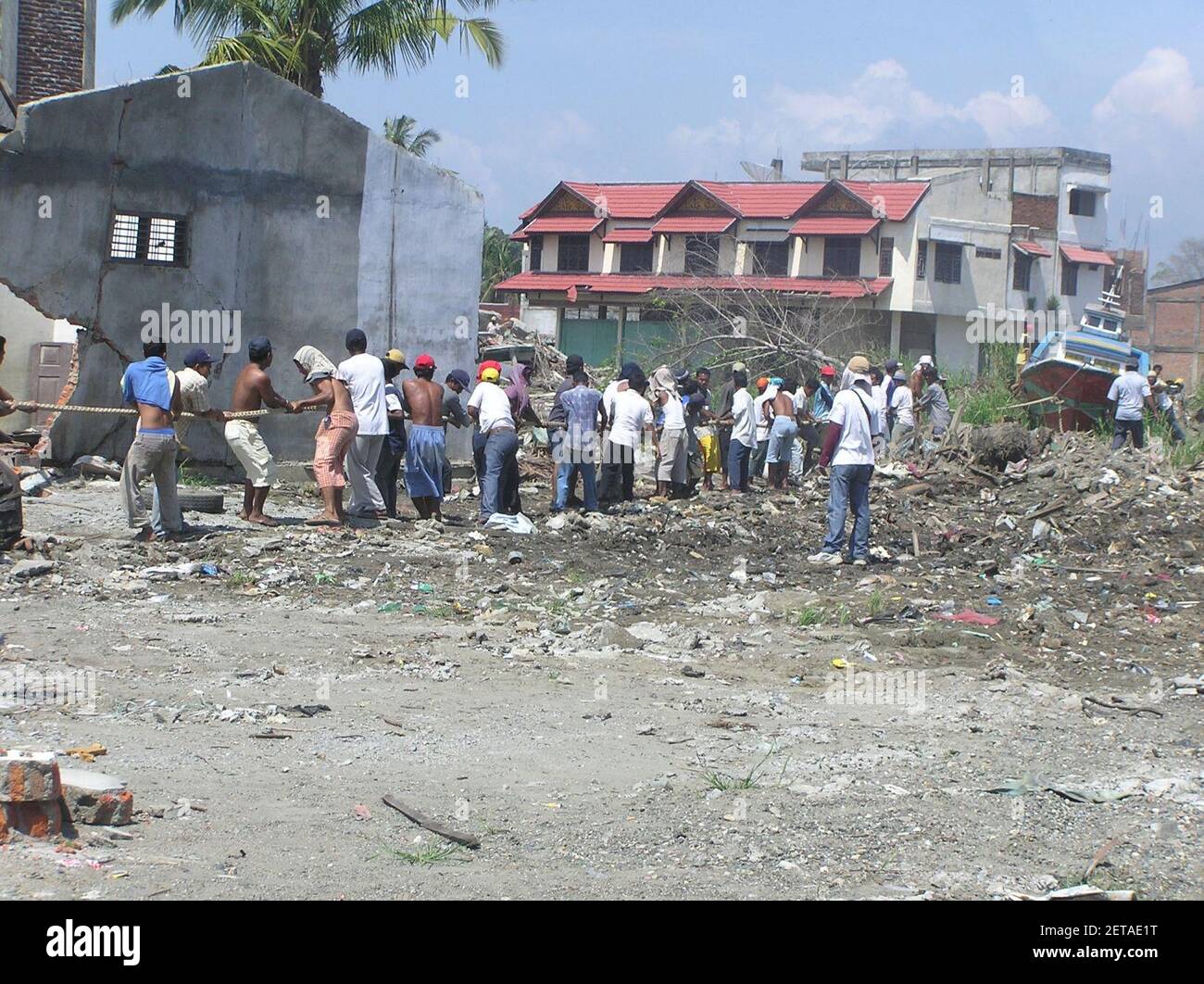 People cleaning up after 2004 earthquake and tsunami disaster; USAID