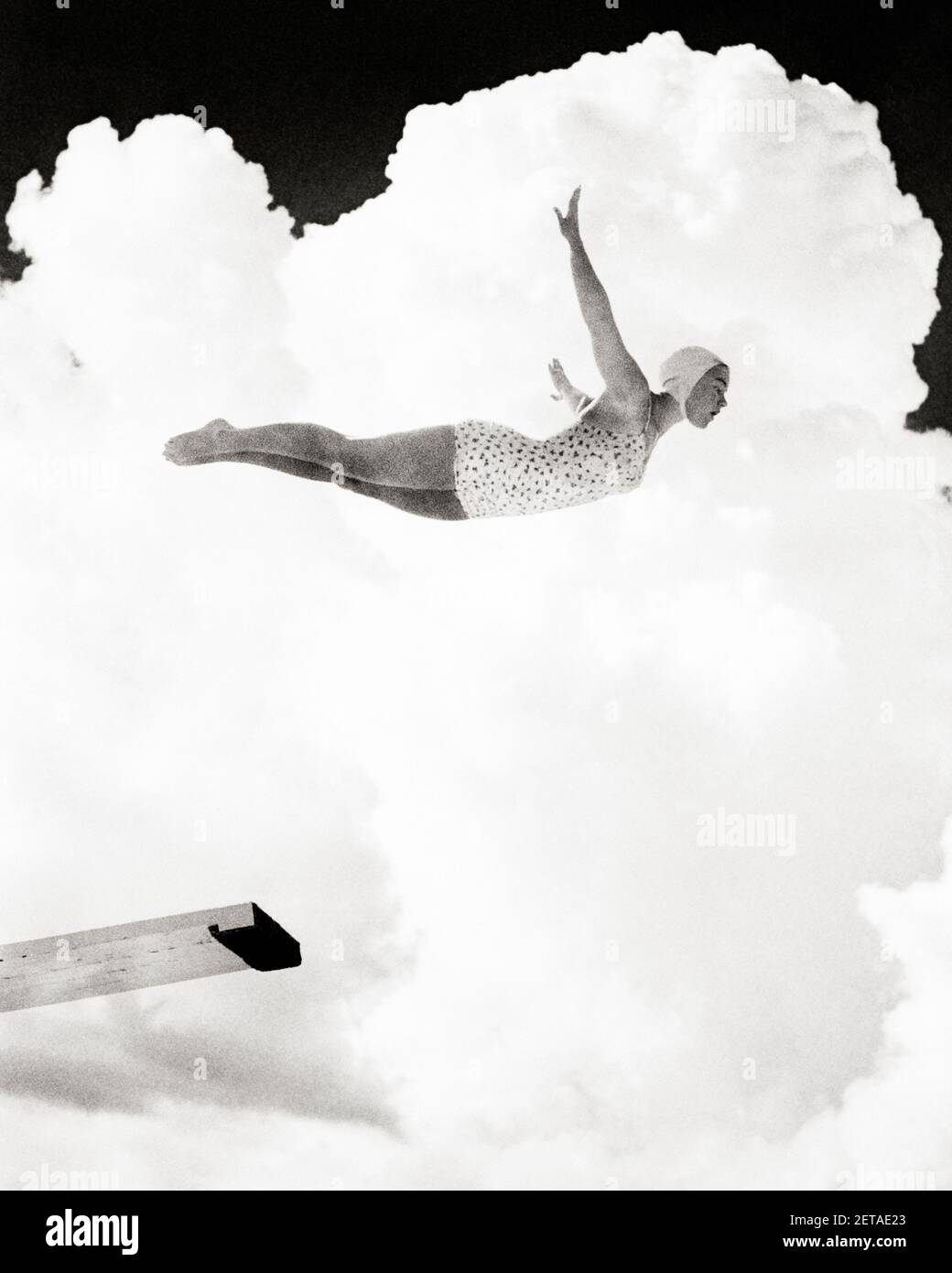 1950s FEMALE SWIMMER PERFORMING SWAN DIVE JUMPING OFF HIGH DIVING BOARD IN MID AIR AGAINST CLOUD BACKGROUND  - s6402 HAR001 HARS DIVE FEMALES CLOUD SWIM HEALTHINESS ATHLETICS COPY SPACE AGAINST FULL-LENGTH LADIES PHYSICAL FITNESS PERSONS INSPIRATION ATHLETIC CONFIDENCE DIVER B&W FORM GOALS CLOUDS ACTIVITY PHYSICAL SWIMMING POOL ADVENTURE STRENGTH COMPOSITE LOW ANGLE POWERFUL RECREATION DIVING BOARD PRIDE SWIMMERS BATHING CAP CONCEPTUAL ATHLETES FLEXIBILITY MIDAIR MUSCLES BATHING SUIT MID SWAN YOUNG ADULT WOMAN BLACK AND WHITE CAUCASIAN ETHNICITY HAR001 OLD FASHIONED Stock Photo