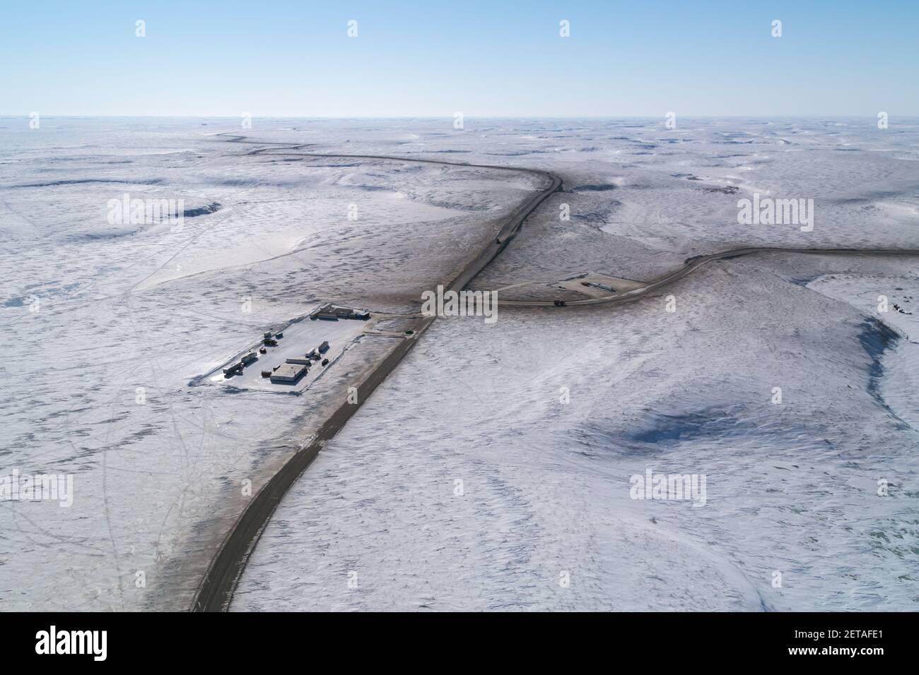 Aerial view of camp and turn off to gravel source 177, winter construction, Inuvik-Tuktoyaktuk Highway, Northwest Territories, Canada's Arctic. Stock Photo