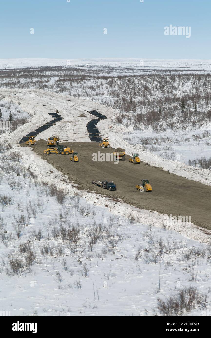 Laying down geotextile fabric (protects permafrost) and spreading gravel on the Inuvik-Tuktoyaktuk Highway, Northwest Territories, Canada's Arctic. Stock Photo