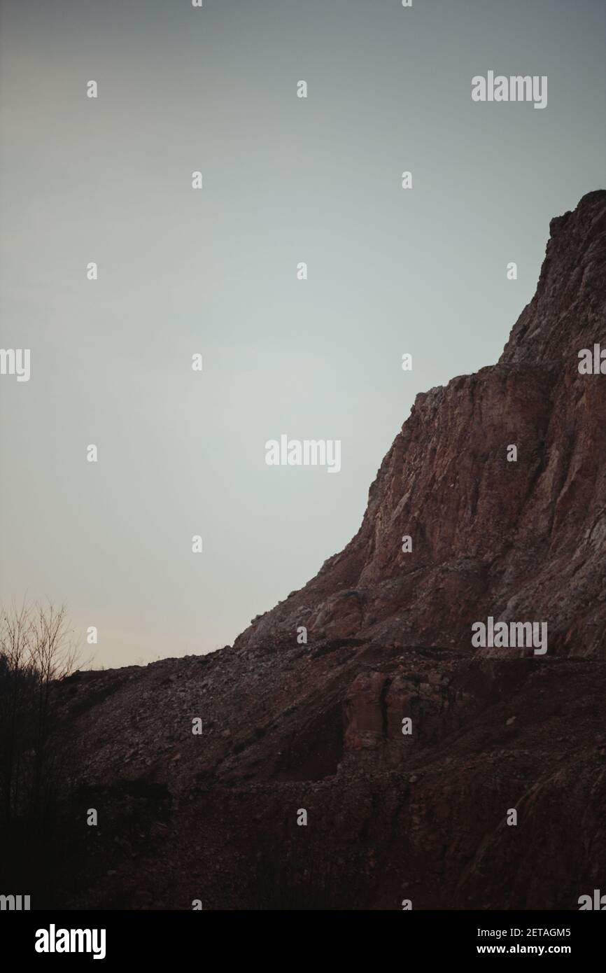 A vertical shot of a rocky mountain against a sky Stock Photo - Alamy