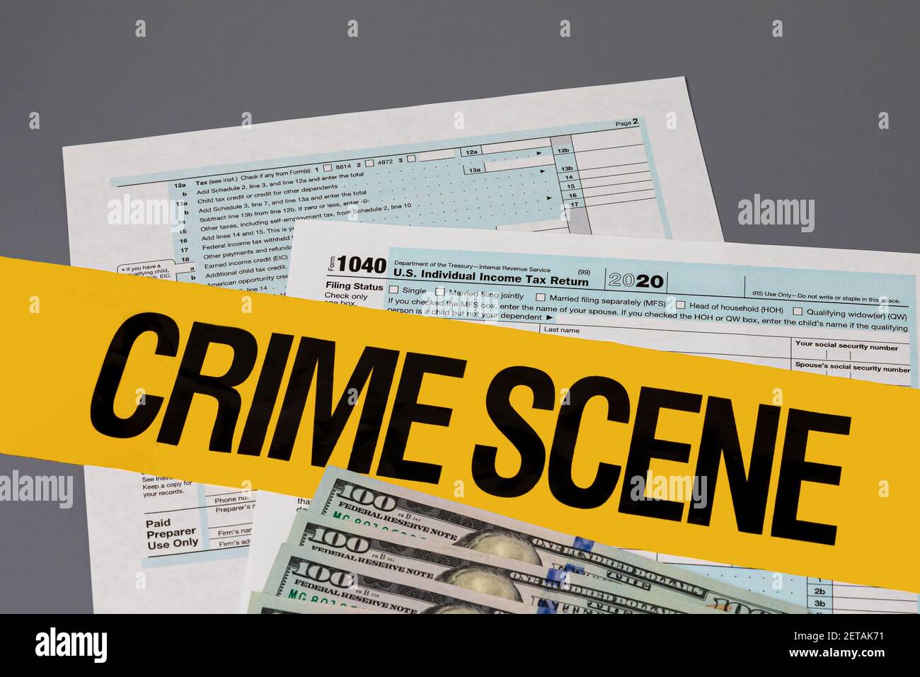 1040 individual income tax return with crime scene tape. Identity theft, tax fraud and cybercrime concept Stock Photo