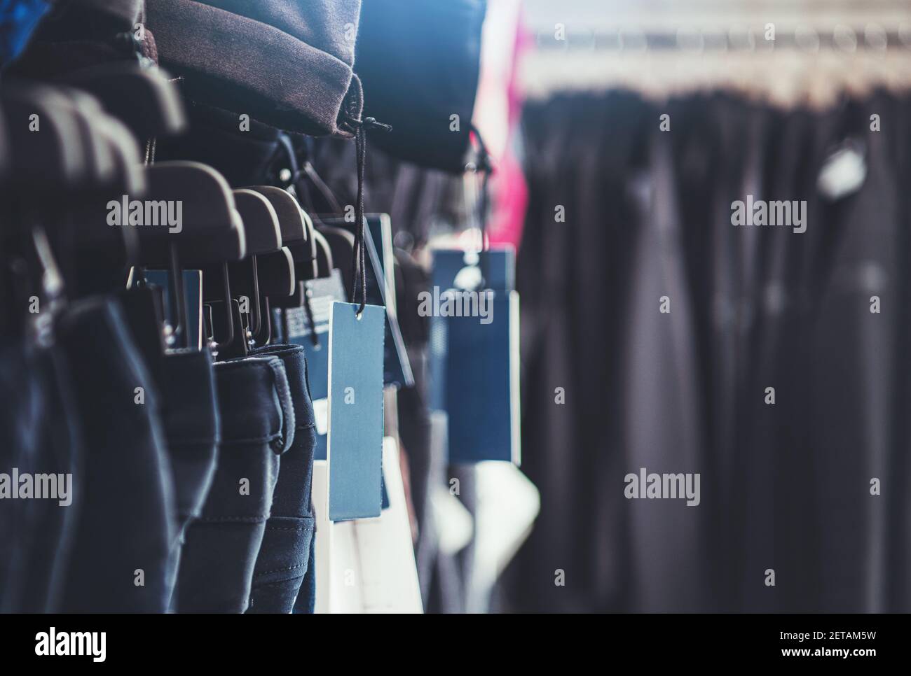 Retail Store Clothes Racks and Price Tags Hanging Close Up. Retail Business Theme Stock Photo